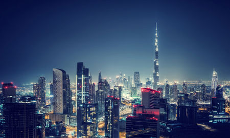 Beautiful Dubai cityscape, bird's eye view on a night urban scene, modern city panoramic landscape, United Arab Emirates (photo via Anna_Om / iStock / Getty Images Plus)