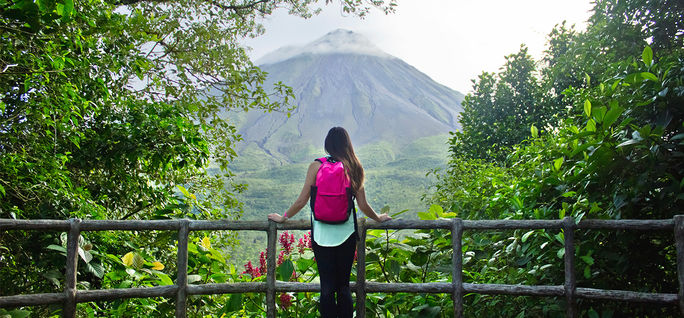 Hiker looking out at the Arenal volcano in La Fortuna Hiker looking out at the Arenal volcano in La Fortuna
